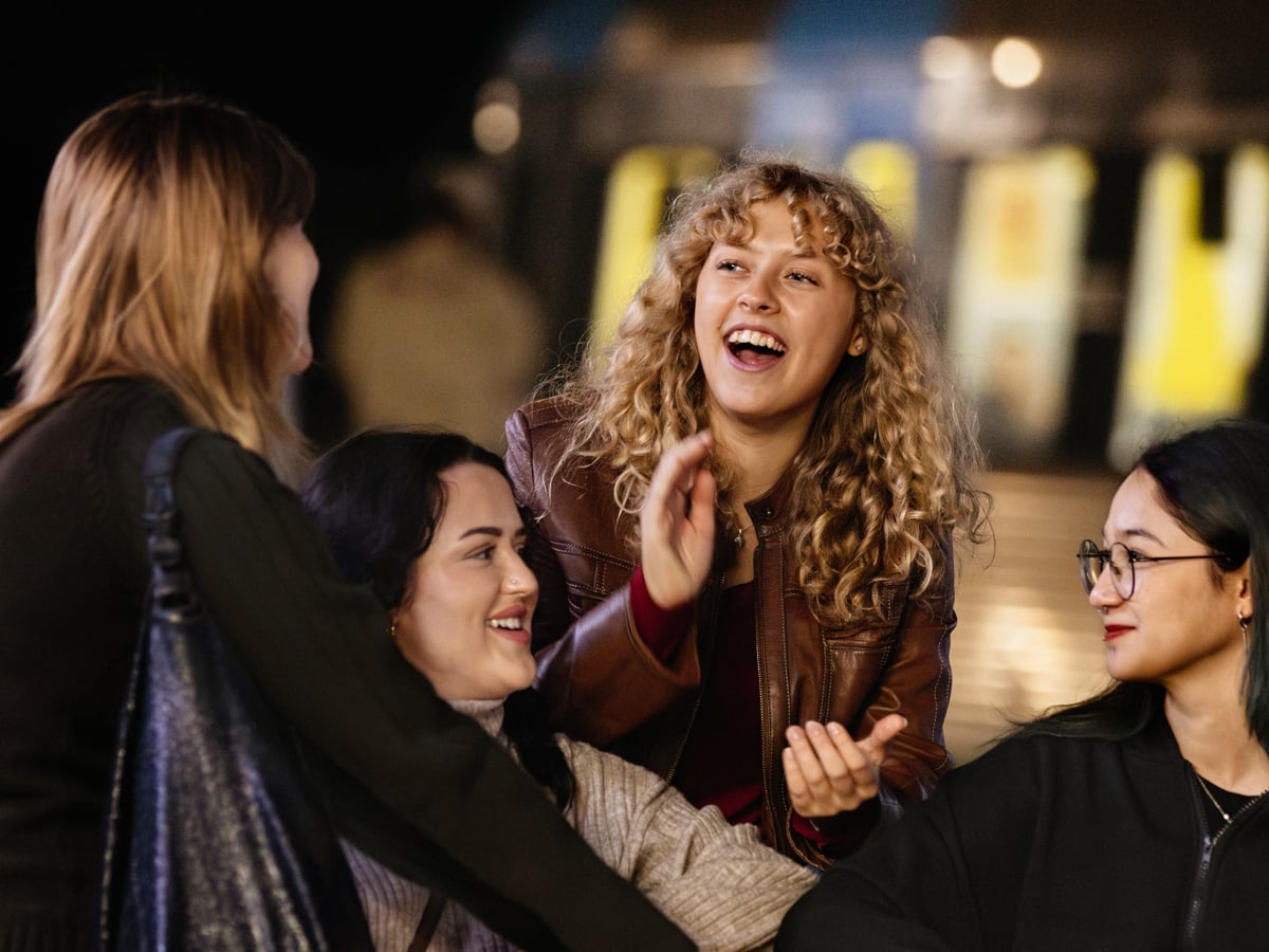 Kvinnor som sitter och pratar vid perrongen i Skärmarbrink.